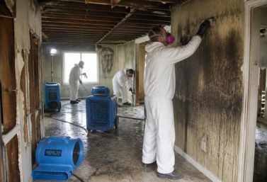 Technicians restoring a residential property after fire and water damage
